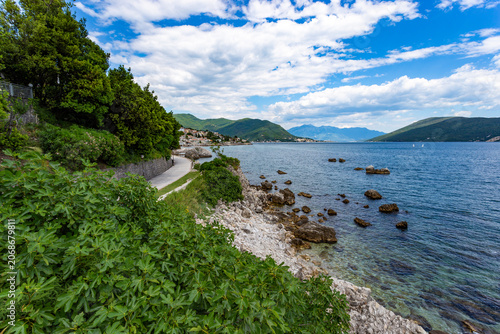 Rugged coastal cliffs and dramatic stone formations meeting the deep blue Adriatic Sea near Herceg Novi, Montenegro
