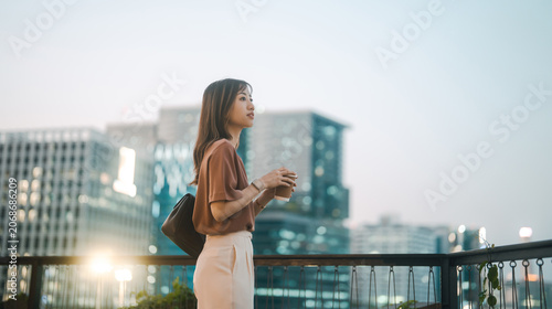 Business asian woman relax drinking coffee urban people lifestyles metropolis building background on night