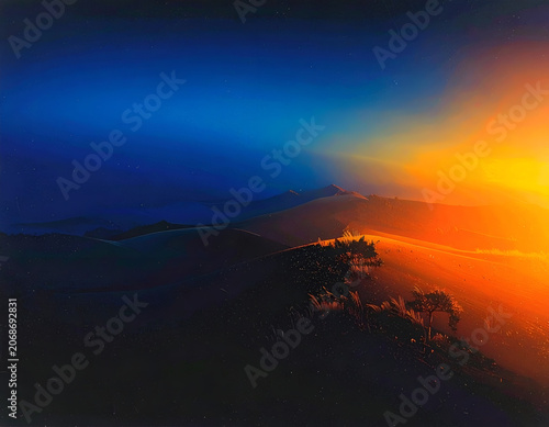 Dramatic Aerial View of Coastal Landscape at Sunset with Vibrant Orange and Blue Hues.