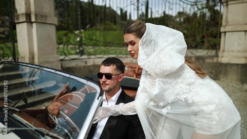 Couple's intimate moment with vintage convertible at a beautiful estate