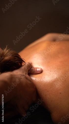 Professional therapist giving a relaxing neck and shoulder massage to a client at a luxury spa