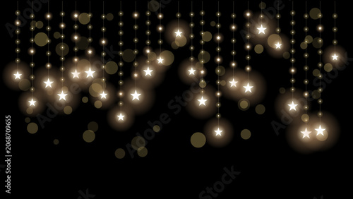 Glowing starshaped fairy lights hanging on strings against a dark