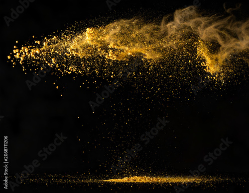 Golden Dust Particles Exploding and Falling Against Black Background.