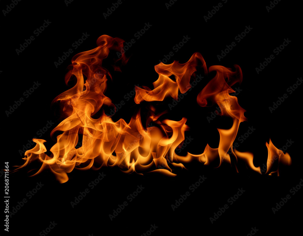 Fototapeta premium A vibrant and dynamic image showcases intense flames against a stark black background, creating a captivating display of heat and energy.