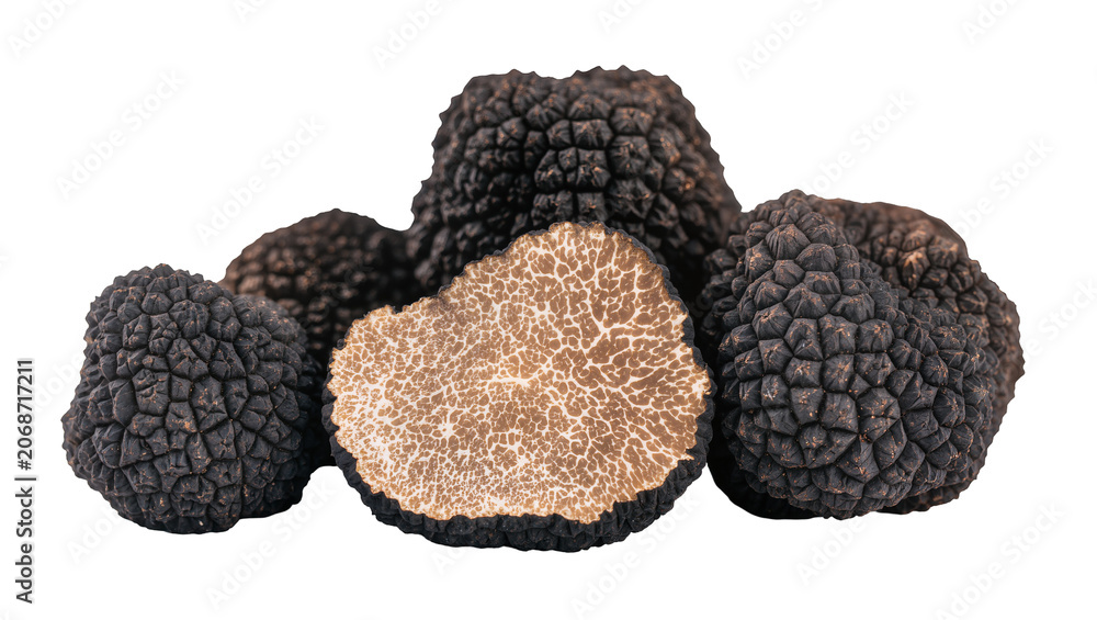 Obraz premium Black truffles with one cut in half showing marbled interior