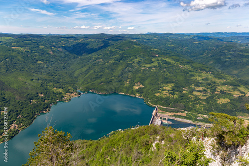 Spectacular high angle perspective of the Bajina Basta dam on the Drina River viewed from a steep cliff overlook in Tara National Park Serbia