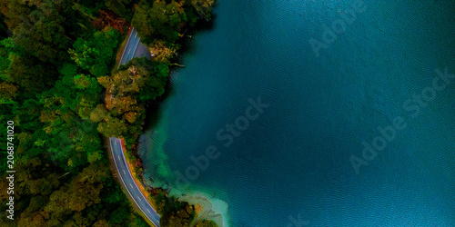 Slika na platnu Aerial view of forest lakes and winding roads, Milford, New Zealand