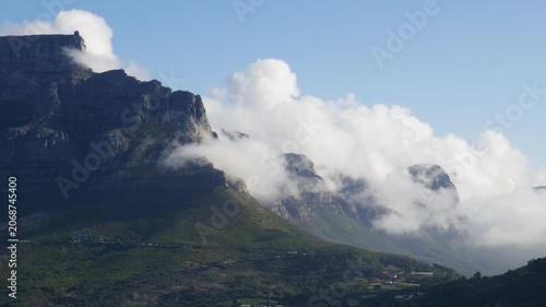 4K 25fps footage from Bloubergstrand showcasing the iconic Cape Town skyline with Table Mountain, Devil’s Peak and Lion’s Head across Table Bay under clear South African blue skies.