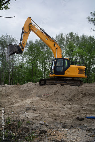 Vertical composition of a wheel excavator on a construction site during earthworks and infrastructure development