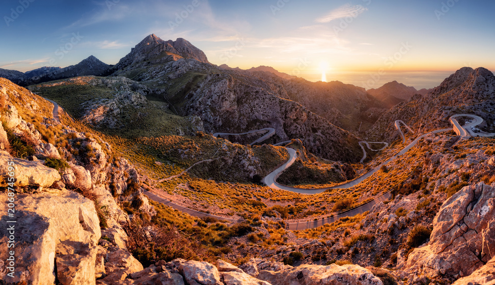 Fototapeta premium Sunset in spanish mountain panorma with road in Sierra de Tramontana Coll dels Reis, island of Mallorca