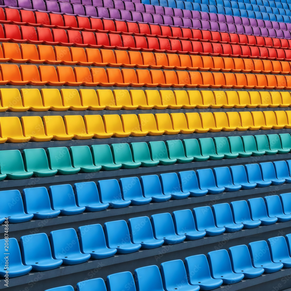 Naklejka premium Rows of colorful stadium seats arranged in a rainbow pattern