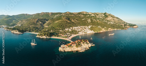 Aerial panorama of Sveti Stefan island resort and Adriatic coastline at sunset in Montenegro