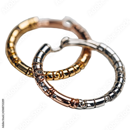 Interlocked jewelry hoops, gold, silver, and rose gold with embedded gems, dark background
