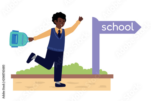 Boy in school uniform with backpack running toward school sign. For education poster, back to school banner, or diversity flyer.