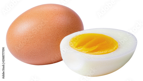 Obraz na płótnie Whole brown egg next to halved hard-boiled egg with yellow yolk