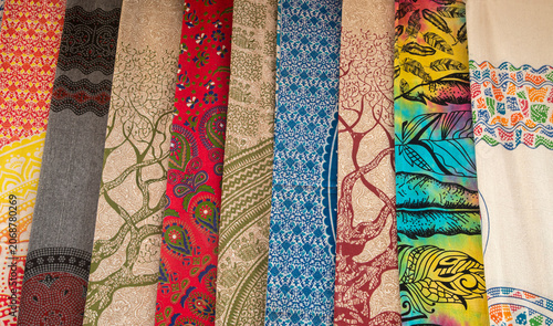 Colorful oriental textiles and fabrics background, traditional patterns on hanging scarfs