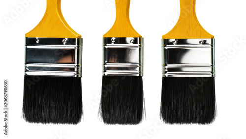 Photos Three yellow handled paint brushes with metal ferrules and black bristles, isola