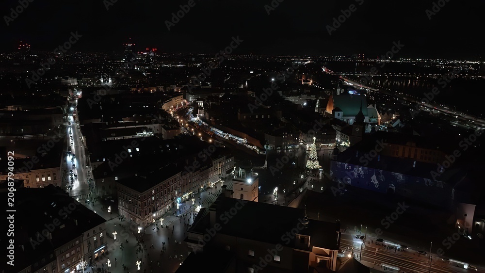 Obraz premium Night cityscape with illuminated buildings and streets