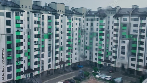 A torrential summer rain.  A view from an apartment window onto a residential complex.