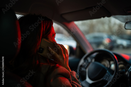 Photos Woman driving car talking on phone at red light