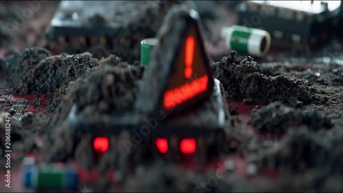 A grubby warning sign on a damaged circuit board symbolises cyber threats, providing a stark backdrop for articles on information security and digital risks.
