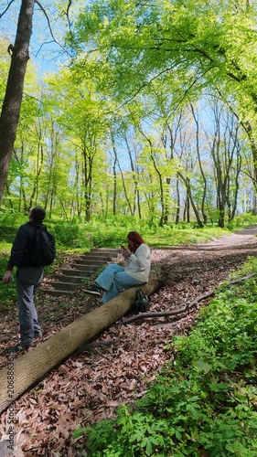 Mature Couple Resting During Hiking Adventure In Fresh Green Spring Forest