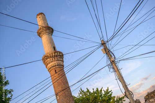 Ottoman Minaret with Muqarnas Detail Rising above Ruined Mosque Walls at Golden Hour -Prilep, North Macedonia