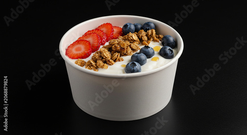 Yogurt bowl with strawberries blueberries and granola