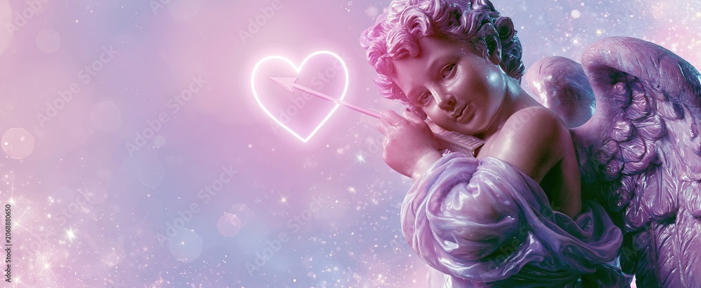 Fototapeta premium Cherub in soft pastel hues holding a glowing heart arrow, set against a dreamy romantic background.
