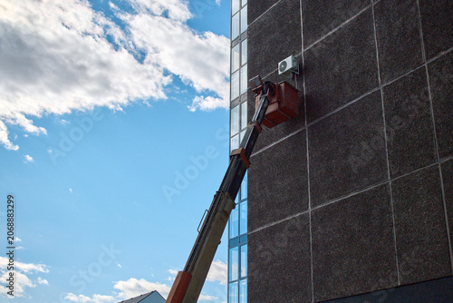 Air conditioner installation on high-rise building facade