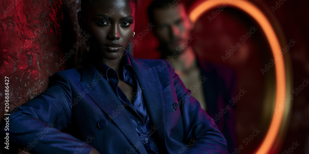 Fototapeta premium bold black ceo in electric blue suit, visionary leader with explosive color contrast, confident female executive with neon power presence