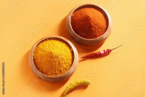 Tableau sur toile Indian spices called turmeric powder and red chili powder isolated on white back