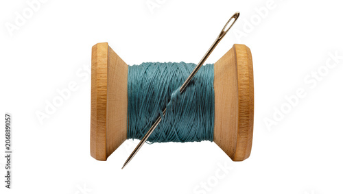 фотографія Wooden spool with teal thread and metal needle, isolated on transparent backgrou
