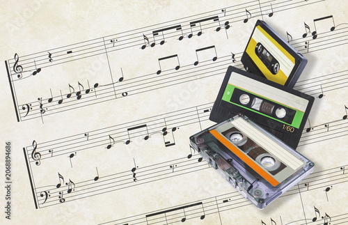 audio cassettes on musical score background