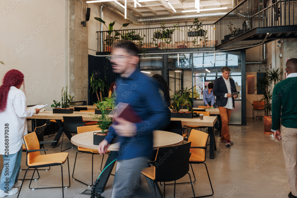 Naklejka premium Business people collaborating in modern coworking office space