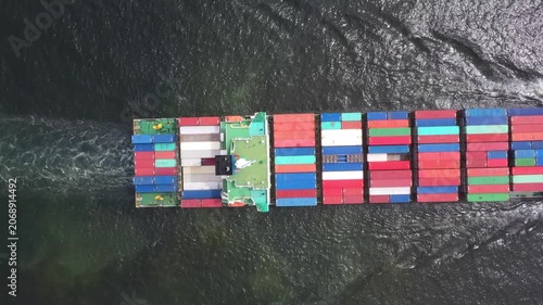 Dynamic Container Ship Transports Vibrant Cargo Across Dark Ocean; Powerful Global Trade Illustration Featuring Numerous Containers In Motion Amidst Rough Seas and Industrial Infrastructure.