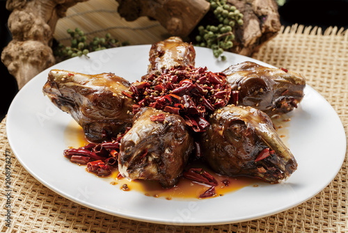 Spicy rabbit heads served on a round white porcelain plate