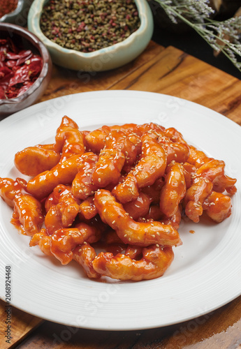 Sweet and sour pork tenderloin served on a round white porcelain plate