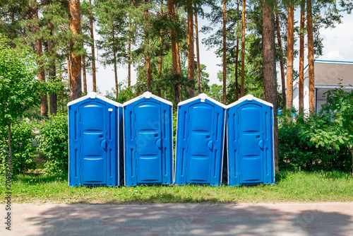 A few portable blue toilets were set up in the city park	