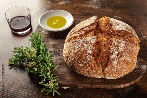 Homemade artisan sourdough bread loaf on a rustic wooden cutting board