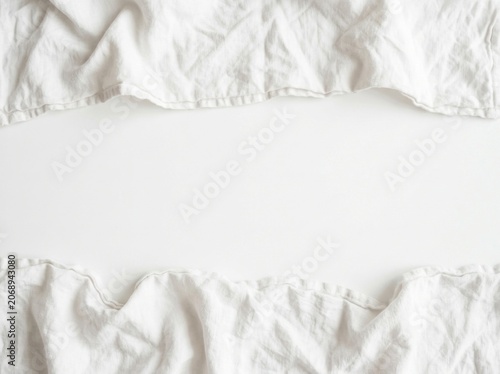 White linen fabric border framing central copy space in a minimalist flat lay with soft shadows for home decor branding