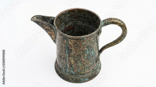 Corroded metal relic with heavy verdigris crust on white background in sharp studio focus for archaeological educational marketing