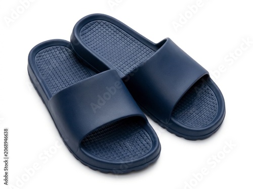 Navy blue rubber slides resting on white background in sharp studio focus for footwear retail marketing
