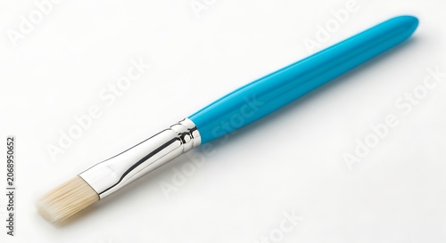 Turquoise handle paint brush with silver ferrule and white bristles isolated