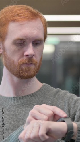 Portrait of Young Man using Smart Watch, Vertical Video