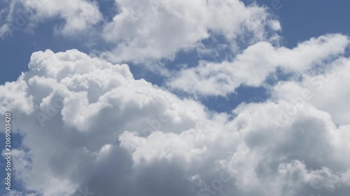 White Cumulus Clouds Moving in Blue Sky