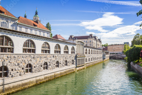 Historic stone colonnade stands along the scenic emerald river in Ljubljana, Slovenia