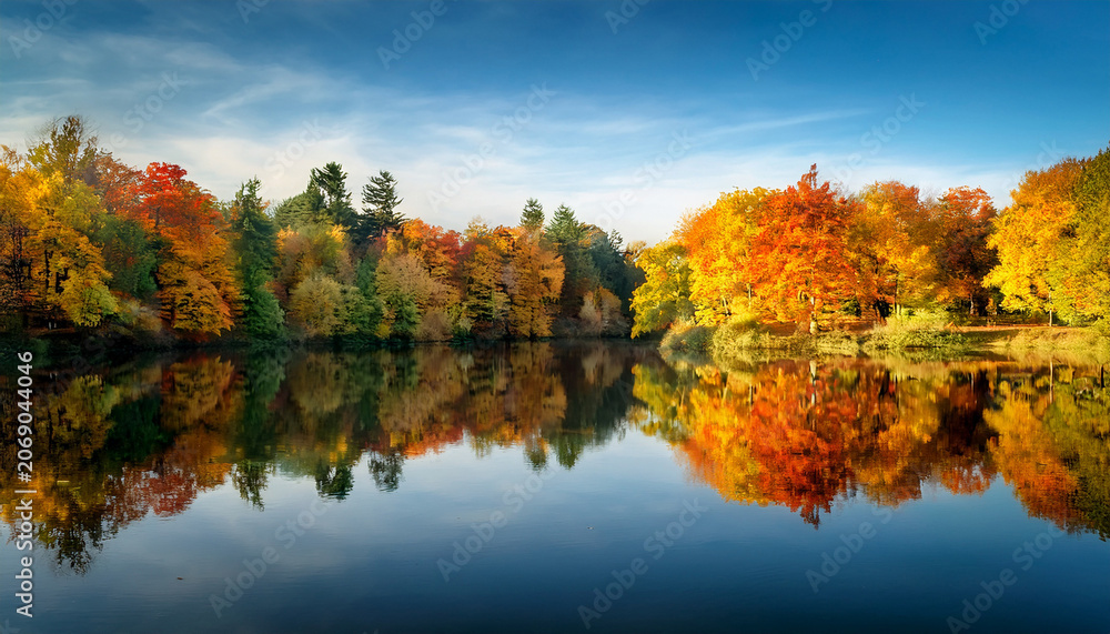 Obraz premium Serene Autumn Landscape With Colorful Trees Reflecting In Calm Water