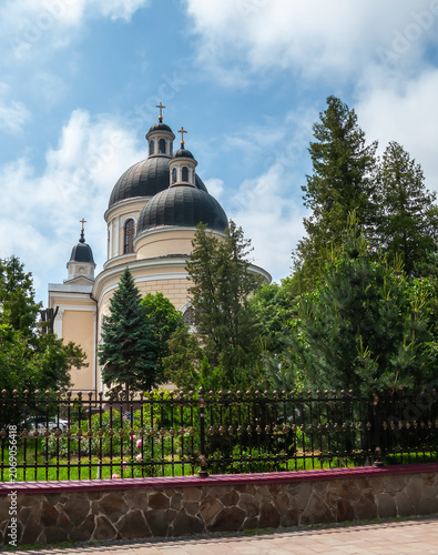 Church building in Chernivtsi, Ukraine with trees and fence on a sunny day