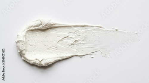 White cosmetic cream smear textured swatch isolated on white background for skincare or beauty product concept